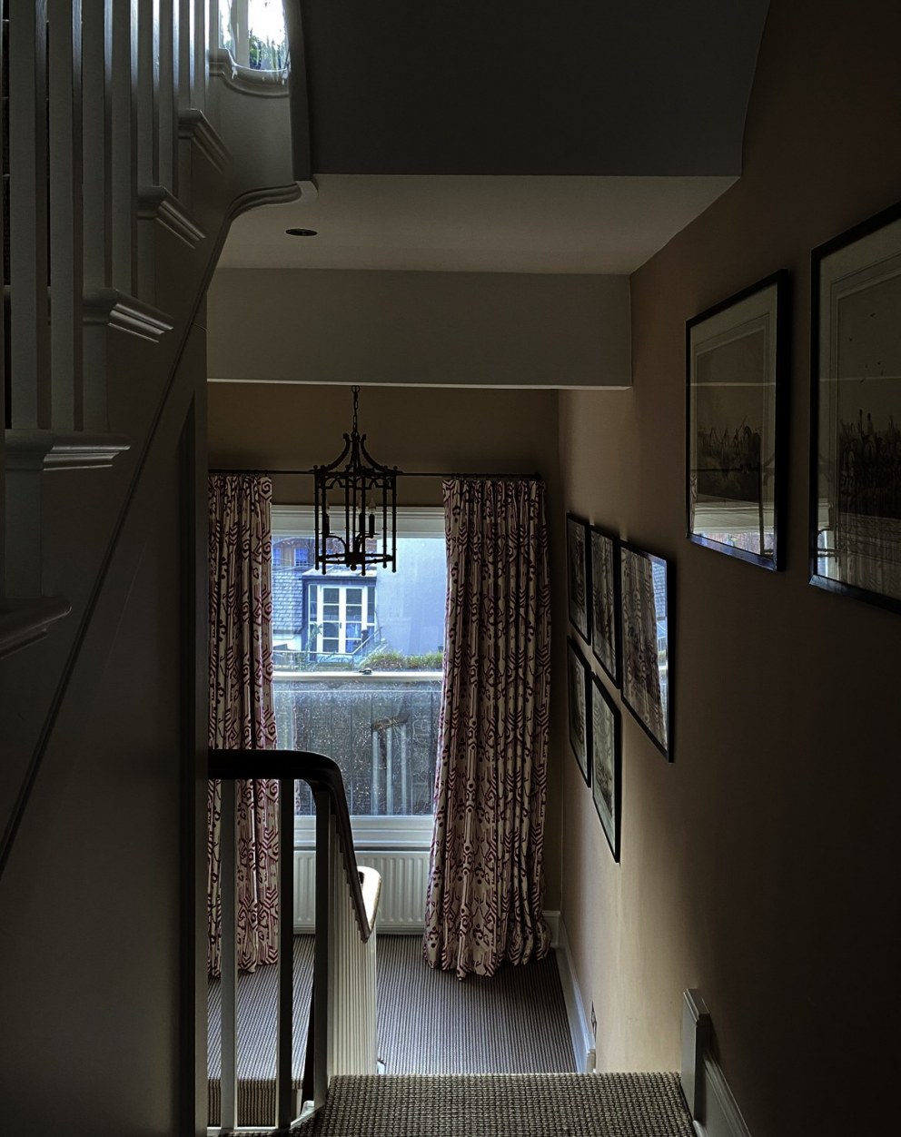 Traveller's London apartment | Entrance hall with antique suzani curtains | Interior Designers